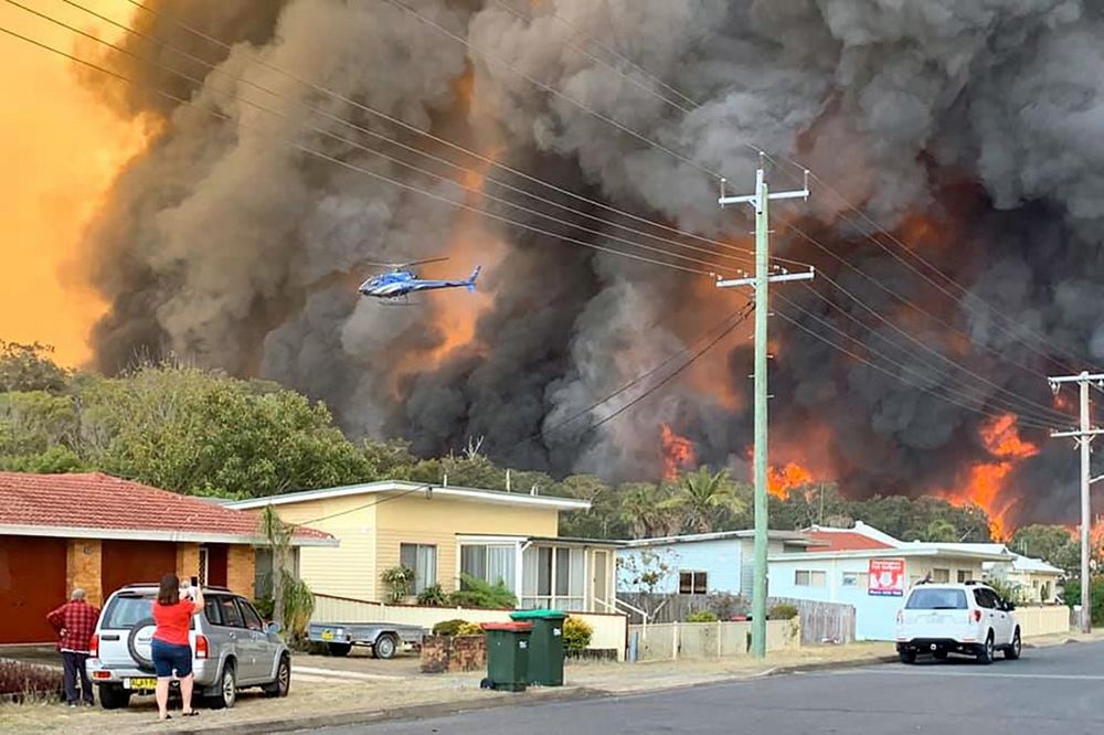 Flames from an out of control bushfire are seen from a nearby residential area in Harrington, some 335 kilometres northeast of Sydney, November 8, 2019. u00e2u20acu201d Kelly-ann Oosterbeek / AFP pic