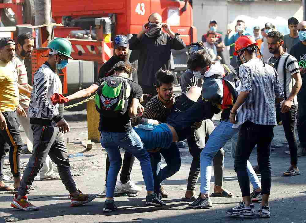 Demonstrators carry a wounded man during the ongoing anti-government protests in Baghdad, Iraq November 11, 2019. u00e2u20acu201d Reuters pic