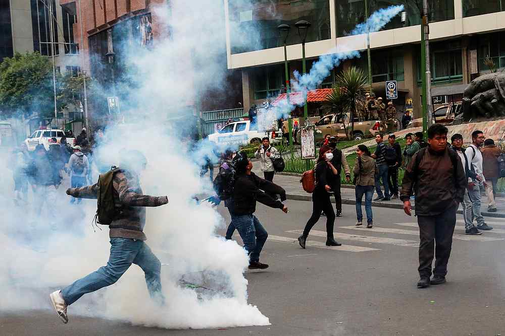 People react amid tear gas during clashes between members of the security forces and supporters of former Bolivian President Evo Morales in La Paz, Bolivia November 13, 2019. u00e2u20acu201d Reuters pic