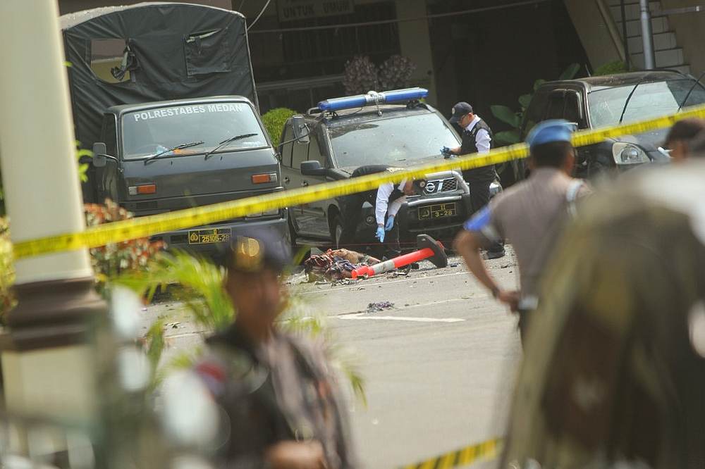 Indonesian police examine a body of a suspected suicide bomber at their headquarters in Medan, North Sumatra after a suicide attack occured during their morning roll call November 13, 2019. u00e2u20acu201d AFP pic