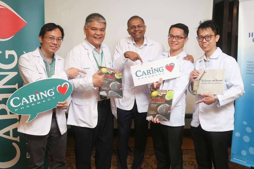 Rajen and Chong with other Caring Pharmacy pharmacists at the Live Well with Diabetes Programme launch. — Picture by Choo Choy May