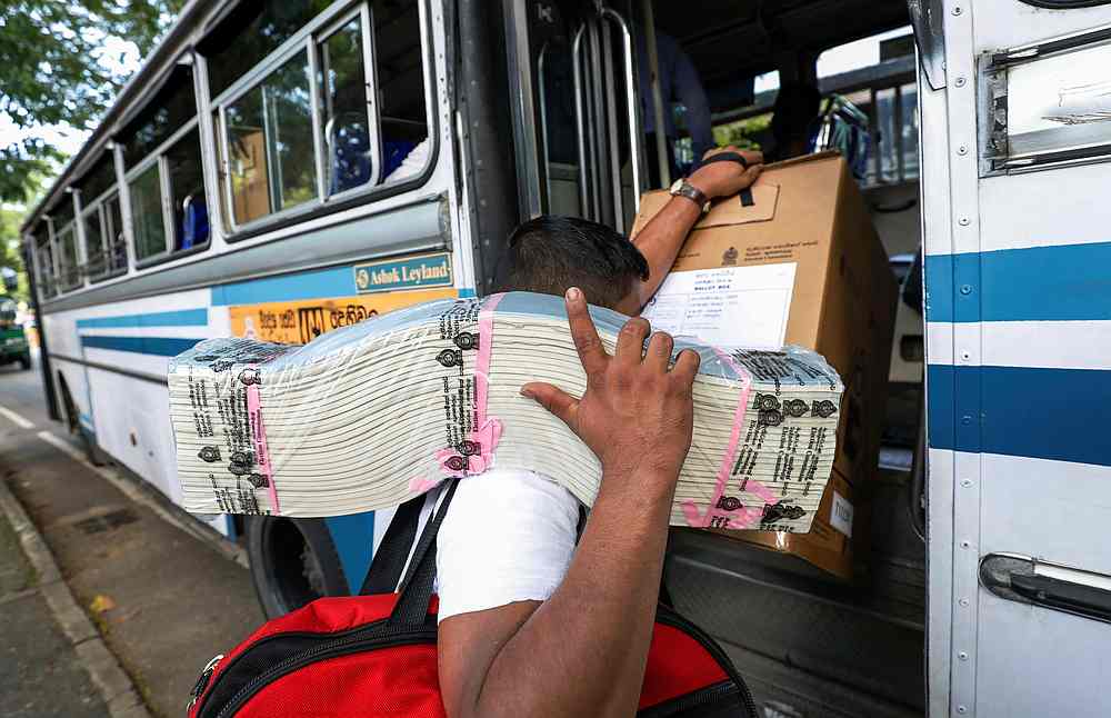 An election official carries ballot papers into a bus from a distribution centre to polling stations, ahead of country's presidential election scheduled on November 16, in Colombo, Sri Lanka November 15, 2019. u00e2u20acu201d Reuters pic