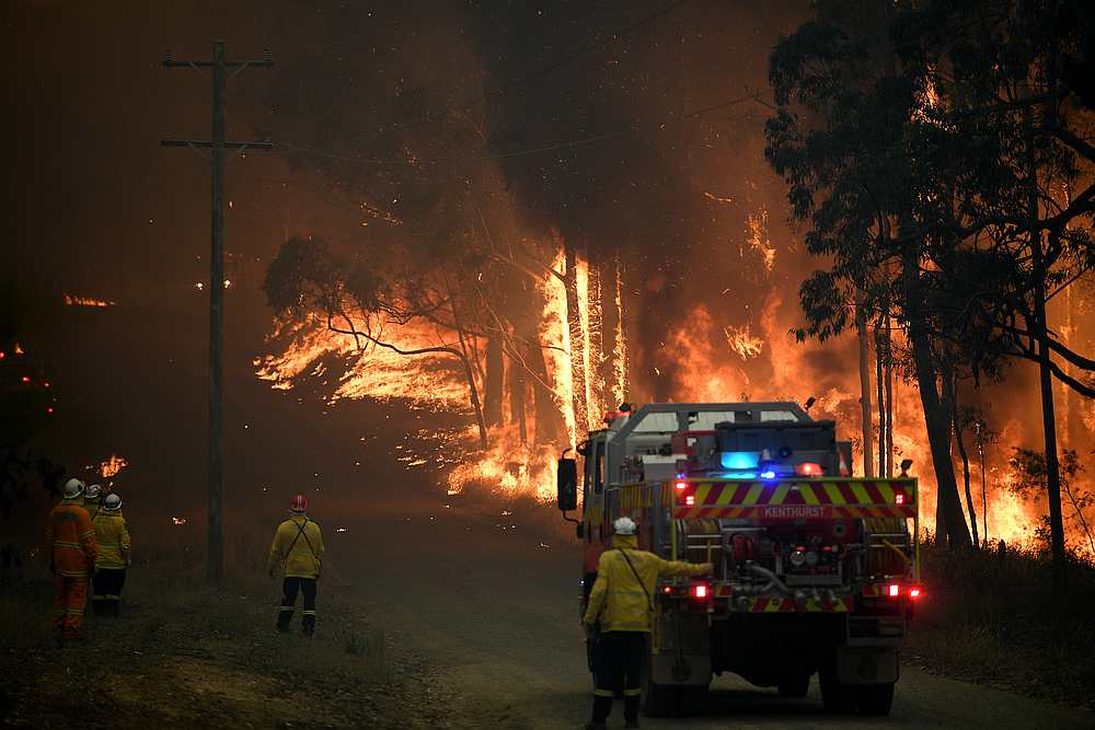 NSW Rural Fire Service crews fight a fire as it burns close to property on Wheelbarrow Ridge Road at Colo Heights, north west of Sydney, Australia November 19, 2019. u00e2u20acu201d AAP Image/Dan Himbrechts via Reuters