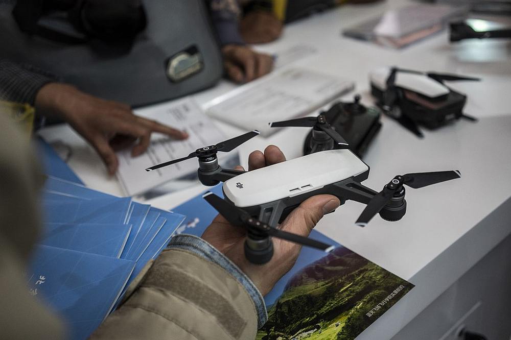A visitor looks at a drone from the Chinese company DJI at the Beijing Photo fair May 4, 2018. u00e2u20acu201d Reuters pic