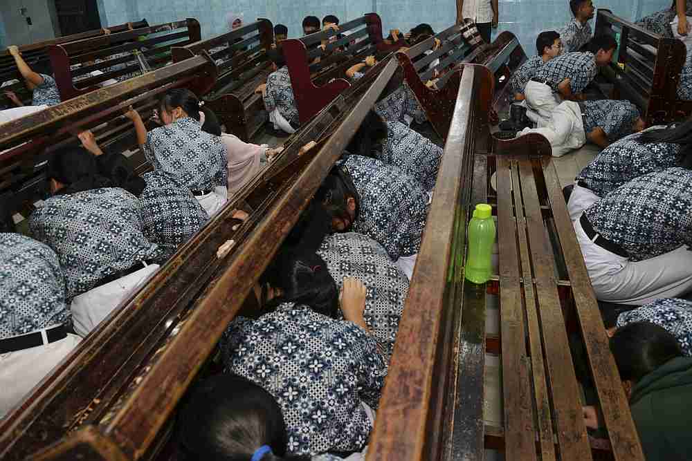 Indonesian students take cover during an earthquake and tsunami drill at a school in Banda Aceh November 14, 2019. u00e2u20acu201d AFP pic
