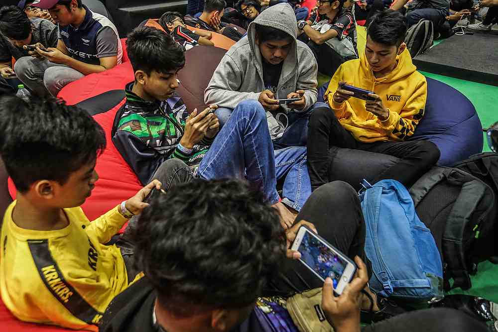 Children may have peers that play games at school and by disallowing them from participating, they may feel like an outcast. — Picture by Firdaus Latif