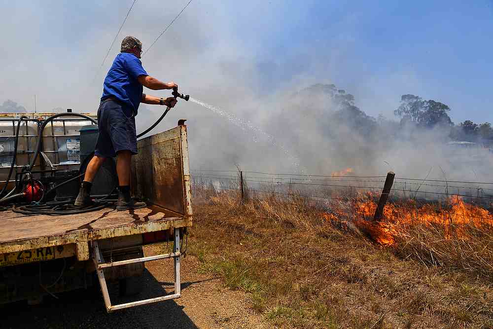 Tinonee resident Brian Acheson sets up his tip truck to assist residents fighting spot and grass fires in the Hillville area near Taree, NSW, Australia November 13, 2019. u00e2u20acu201d AAP Image/Dean Lewins via Reuters
