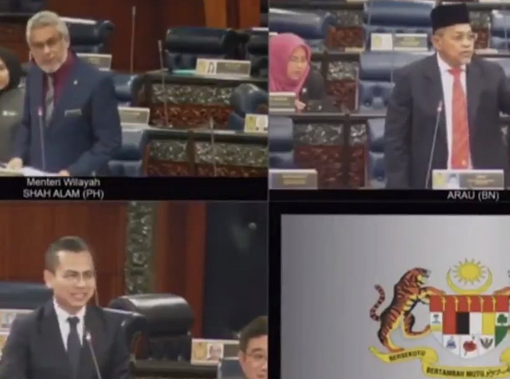 Members of Parliament smile when Arau MP Datuk Seri Shahidan Kassim informs that Malaysia has taken the lead against Indonesia. u00e2u20acu201d Screengrab via Twitter/@HafizRayyan