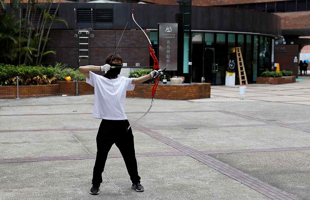 A protester practises shooting with bow and arrow at the besieged Hong Kong Polytechnic University (PolyU)November 20, 2019. u00e2u20acu201d Reuters pic