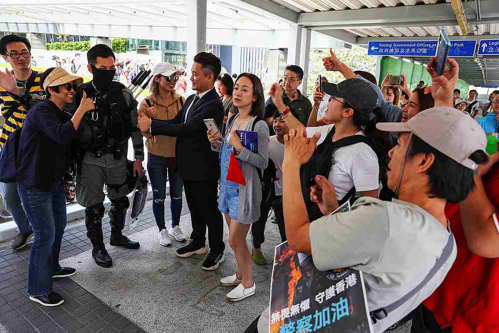 A pro-government supporter poses with a riot policeman during a rally at the Legislative Council (LegCo) building in Hong Kong November 16, 2019. u00e2u20acu201d Reuters pic