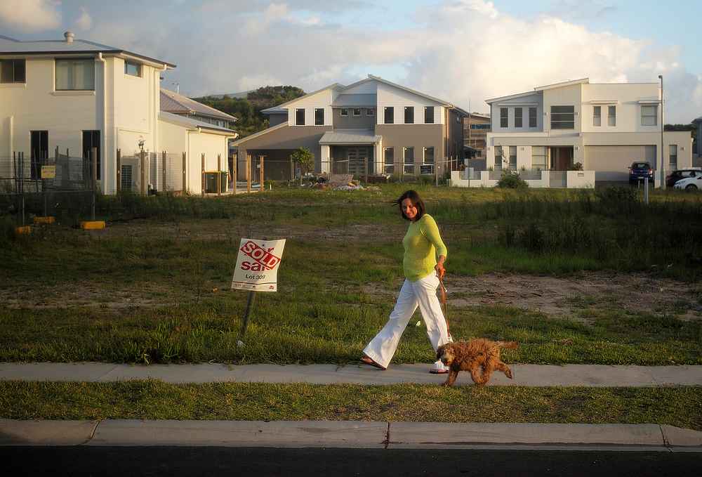 A resident in Sydney's newly-developed beachside suburb of Green Hills walks her dog February 2, 2015. u00e2u20acu201d Reuters pic