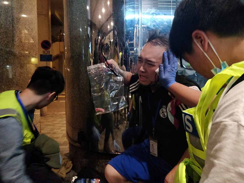 Andrew Chiu Ka Yin, District Councillor of Taikoo Shing West, receives help from first aid volunteers after sustaining an injury in a knife attack at a shopping mall, in Taikoo Shing in Hong Kong November 3, 2019. u00e2u20acu201d Reuters pic