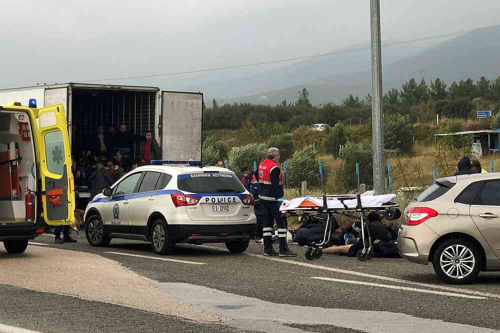 Migrants are seen inside a refrigerated truck as others lie on the road, after a police check at a motorway near Xanthi Greece, November 4, 2019. u00e2u20acu201d Reuters pic