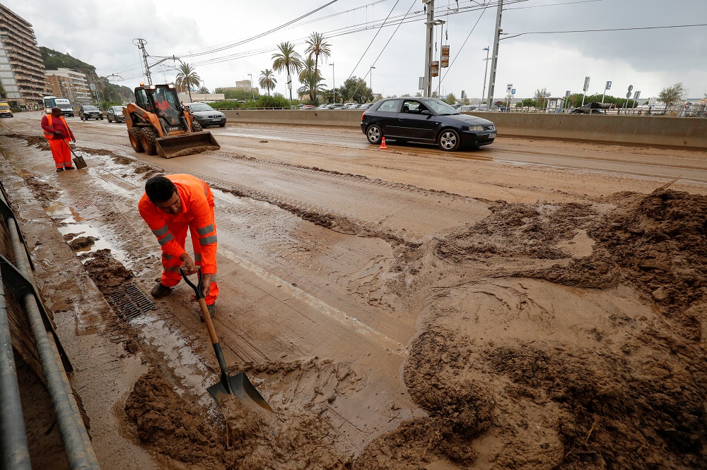 Workers remove mud of the N-II road after floods caused by torrential rains in Arenys de Mar, north of Barcelona, Spain October 23, 2019. u00e2u20acu201d Reuters pic