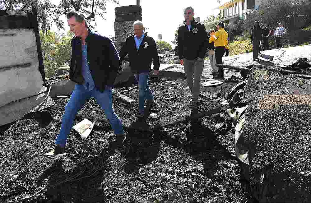 California Governor Gavin Newsom (left) views a burned home along Tigertail Road in Brentwood, California October 29, 2019. u00e2u20acu201d Wally Skalij/Pool pic via Reuters