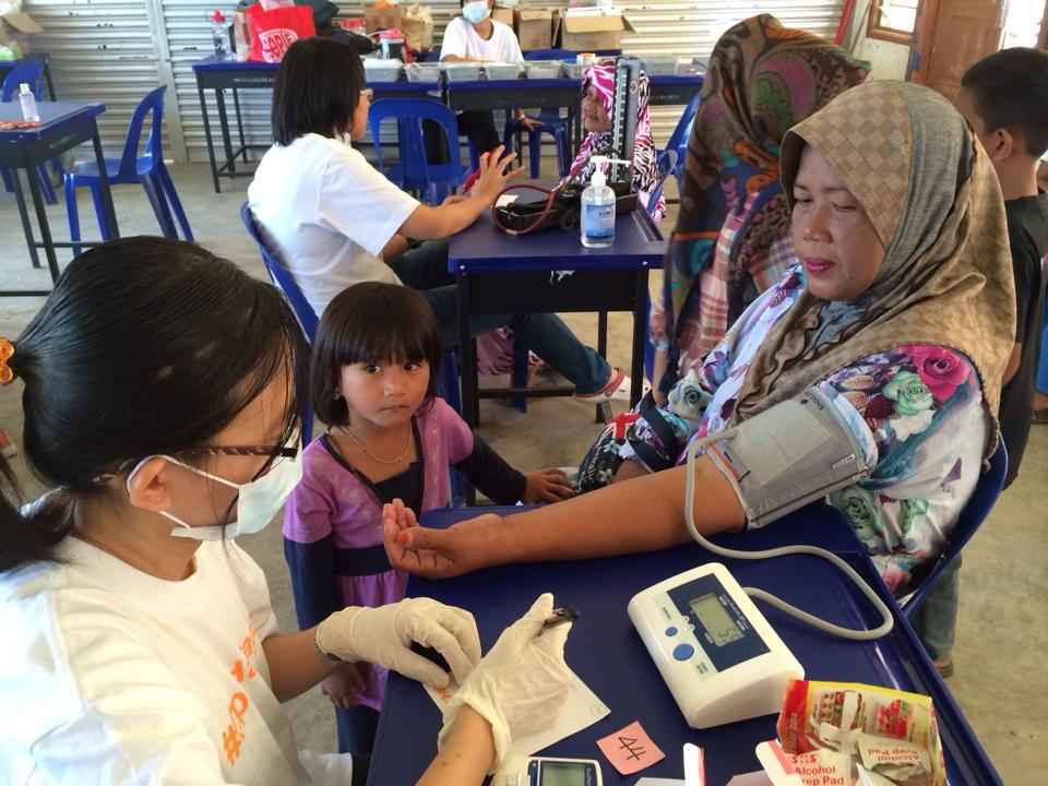 An Ops Harapan volunteer pharmacist checks a woman’s blood pressure. — Picture courtesy of Ops Harapan