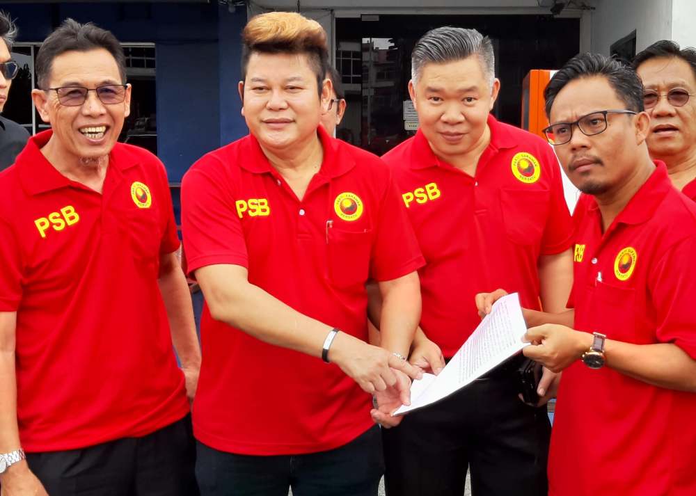 PSB Youth information chief Frankie Junau (right) with Youth leader Johnical Rayong (second left) and PSB member Abang Mohammed Tosen (left) after lodging the police report, November 27, 2019. u00e2u20acu2022 Picture by Sulok Tawie