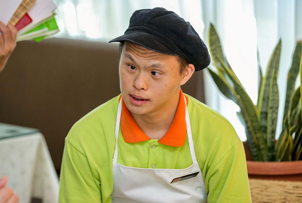 Jason Ng Foo Guan says he's s happy and proud to be working at Ray of Hope cafe, where he is the supervisor.  — Picture by Farhan Najib