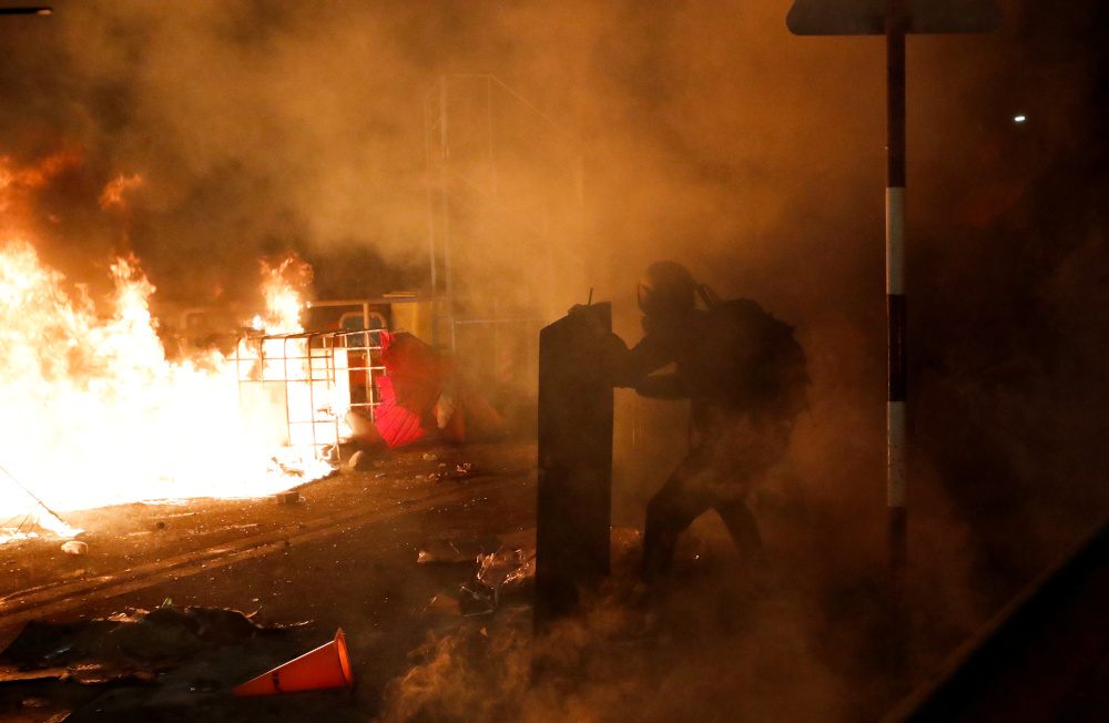 A protester takes cover during a standoff with riot police at the Chinese University of Hong Kong, Hong Kong November 12, 2019. u00e2u20acu201d Reuters pic