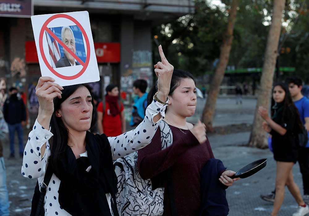 A demonstrator holds up a sign with a picture of Chile's President Sebastian Pinera during a protest against Chile's government at Plaza Italia in Santiago November 5, 2019. u00e2u20acu201d Reuters pic