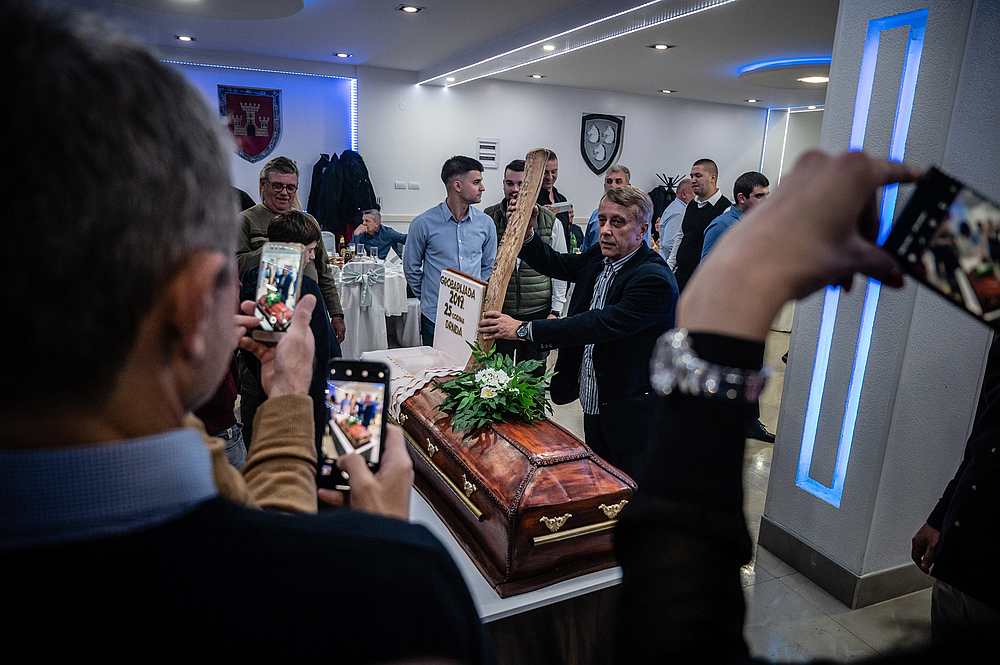 Guests take pictures with mobile phones at the gigantic coffin-shaped cake during the Serbia's annual undertaker's ball. u00e2u20acu201d AFP pic