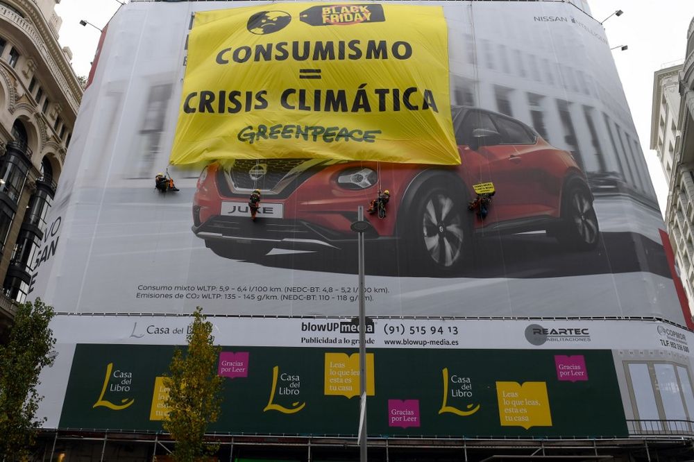 Greenpeace activists unfold a big banner reading u00e2u20acu02dcBlack Friday u00e2u20acu201c Consumerism = Climate Crisisu00e2u20acu2122 on a facade of a building in Gran Via street in Madrid, November 29, 2019. u00e2u20acu201d AFP pic