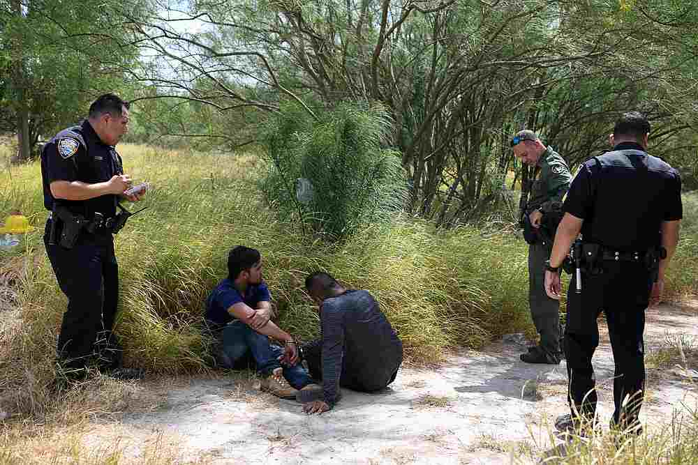 Migrant men sit on the ground after being detained by law enforcement for illegally crossing the Rio Grande and attempting to evade capture in Hidalgo, Texas August 23, 2019. u00e2u20acu201d Reuters pic
