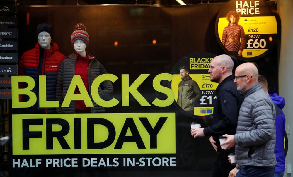 People walk past a sign advertising Black Friday offers in the window of a Blacks outdoor clothing store in Manchester, Britain November 22 2019. u00e2u20acu201d Reuters pic