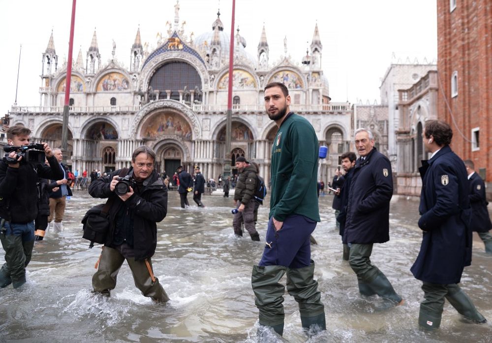 AC Milanu00e2u20acu2122s goalkeeper Gianluigi Donnarumma walks in St Mark square on November 16, 2019 in Venice, three days after the city suffered the highest tide in 50 years. u00e2u20acu201d AFP pic