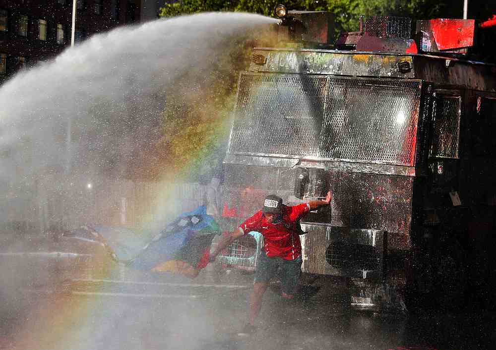 A demonstrator is sprayed by security forces with a water cannon during an anti-government protest in Santiago, Chile October 31, 2019. u00e2u20acu201d Reuters pic