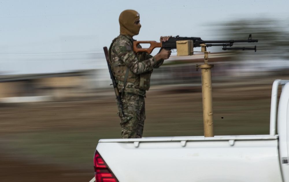 A masked fighter with the Kurdish Peopleu00e2u20acu2122s Protection Units (YPG) mans a machine gun mounted on a truck during a patrol in the north-eastern Syrian town of al-Malikiyah (Derik) at the border with Turkey, November 3, 2019. u00e2u20acu201d AFP pic