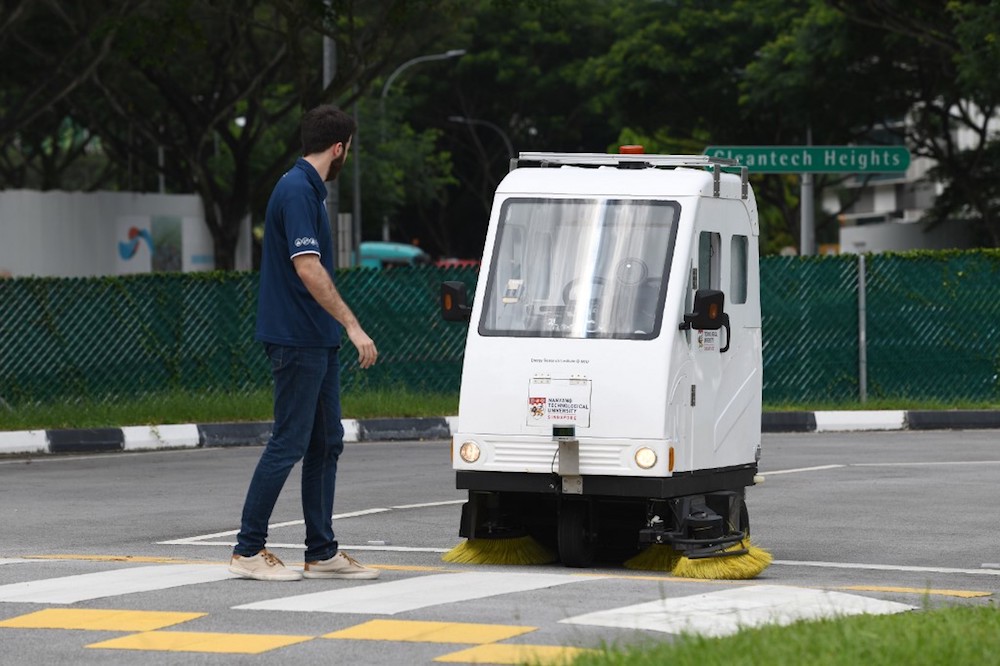 An autonomous road sweeper stops as it reacts to a pedestrian walking during a trial test at CETRAN run by the Nanyang Technological University (NTU) in Singapore December 5, 2019. u00e2u20acu201d AFP pic