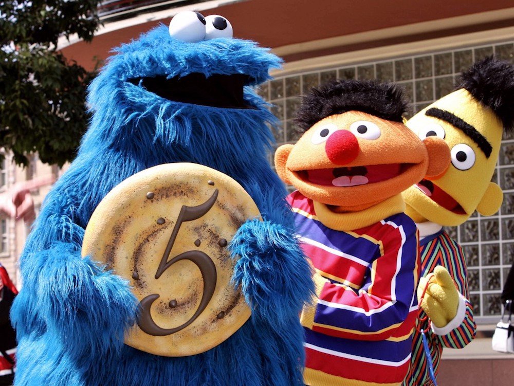 u00e2u20acu02dcSesame Streetu00e2u20acu2122 character Cookie Monster shows a large cookie with the figure five to celebrate the fifth anniversary of Hollywood theme park Universal Studios Japan in Osaka April 20, 2006, while Ernie and Bert smile. u00e2u20acu201d AFP pic