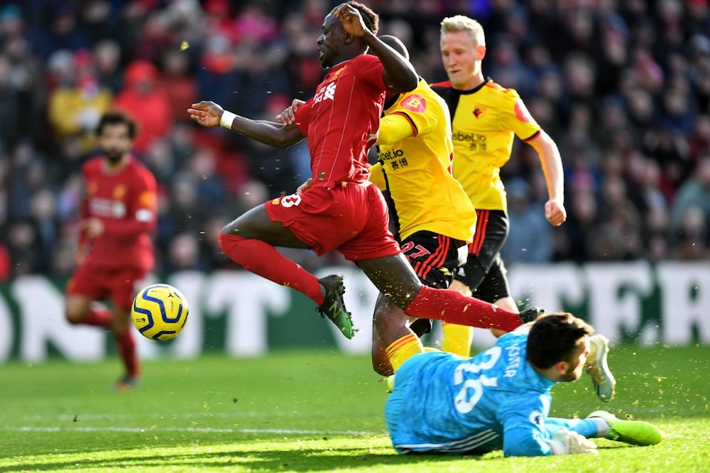 Liverpoolu00e2u20acu2122s Sadio Mane leaps over Watfordu00e2u20acu2122s goalkeeper Ben Foster during their Premier League match at Anfield in Liverpool December 14, 2019. u00e2u20acu201d AFP pic