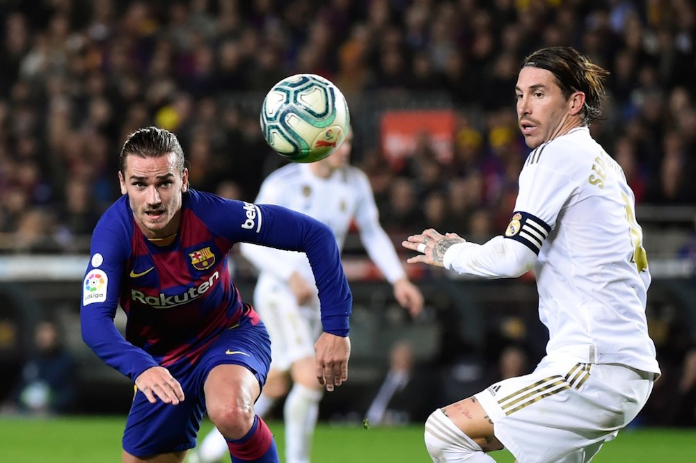 Barcelonau00e2u20acu2122s Antoine Griezmann and Real Madridu00e2u20acu2122s Sergio Ramos eye the ball during their La Liga match at Camp Nou Stadium in Barcelona December 18, 2019. u00e2u20acu201d AFP pic