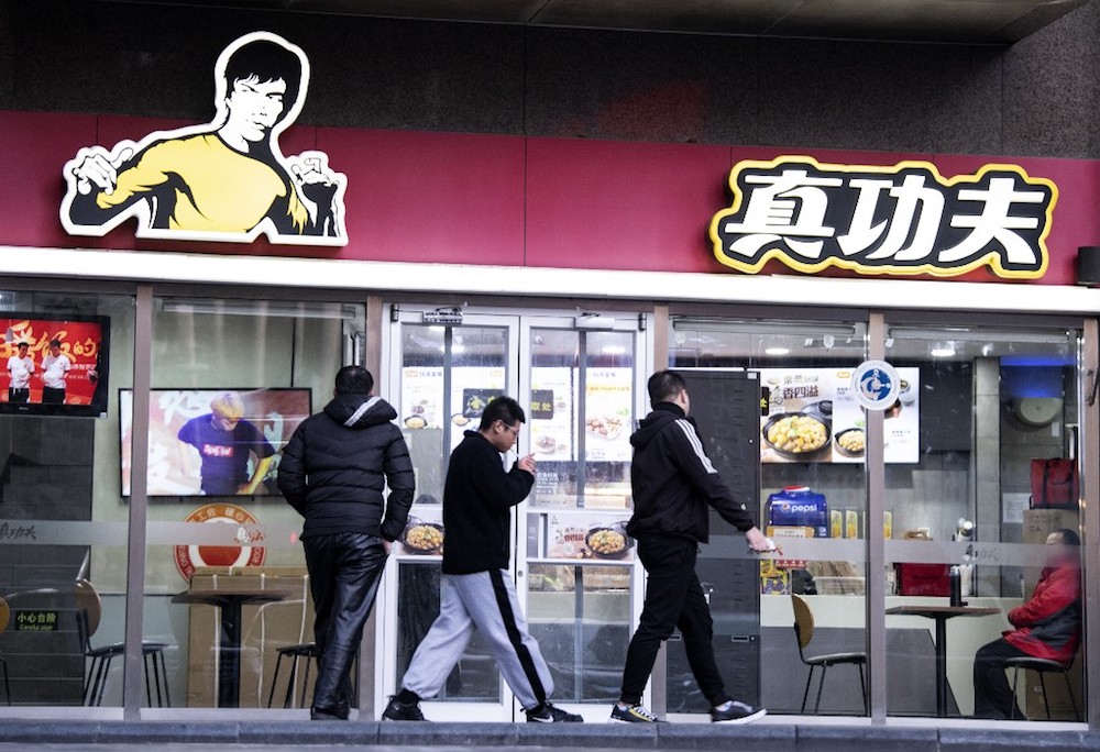 People walk past the restaurant Real Kung Fu, or Zhen Gongfu in Mandarin, run by fast food chain Kungfu Catering Management, in Beijing December 26, 2019. u00e2u20acu201d AFP pic