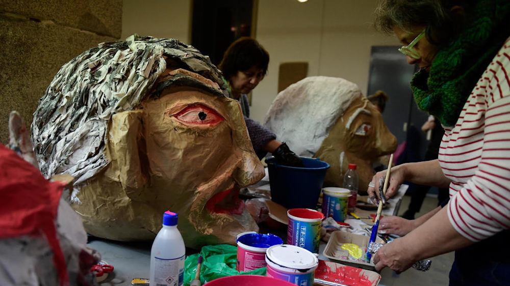 Activists working to finish giant papier-mache heads in Madrid December 6, 2019. u00e2u20acu201d AFP pic
