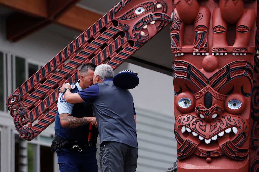 A police officer hugs a man after Ngati Awa representatives and relatives of the volcano eruption victims leave a ceremony called u00e2u20acu02dcKarakiau00e2u20acu2122 at Mataatua Marae house in Whakatane December 12, 2019. u00e2u20acu201d Reuters pic