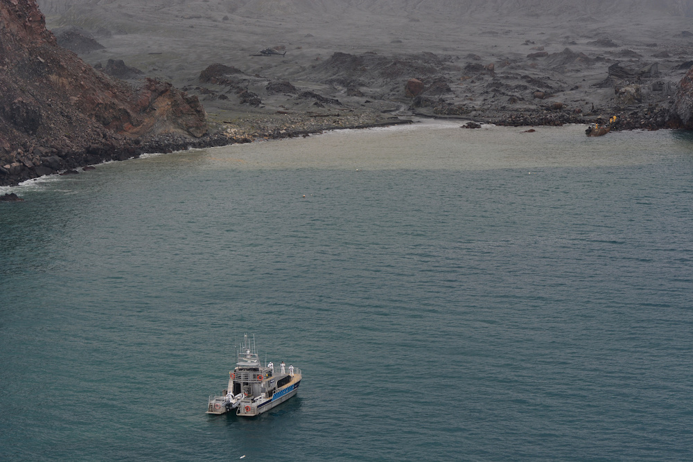 Members of a rescue crew are seen at the White Island volcano in New Zealand December 13, 2019, in this image obtained via social media. u00e2u20acu201d New Zealand Defence Force handout via Reuters
