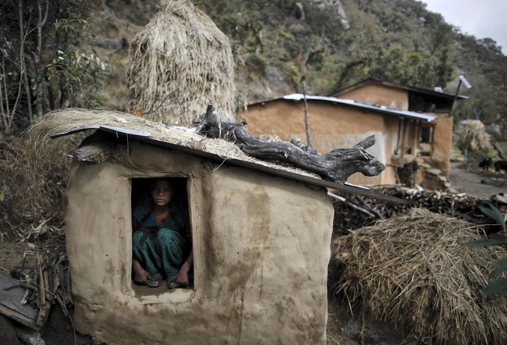 Uttara Saud, 14, sits inside a Chaupadi shed in the hills of Legudsen village in Achham District in western Nepal February 16, 2014. u00e2u20acu201d Reuters pic