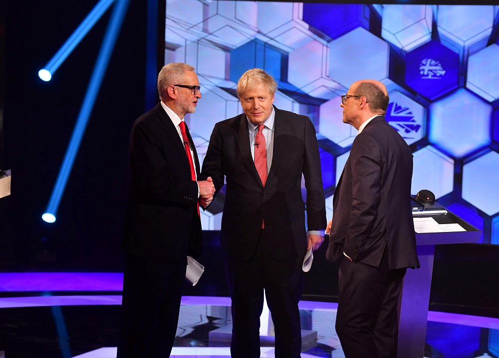 Britain's Prime Minister Boris Johnson and opposition Labour Party leader Jeremy Corbyn shake hands during a head-to-head debate on the BBC in London December 6, 2019. u00e2u20acu201d Picture by Jeff Overs/BBC/Handout via Reuters