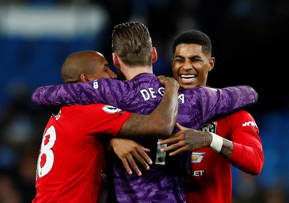 Manchester Unitedu00e2u20acu2122s Marcus Rashford, Ashley Young and David de Gea celebrate after the Premier League match with Manchester City at Etihad Stadium in Manchester December 7, 2019. u00e2u20acu201d Action Images pic via Reuters