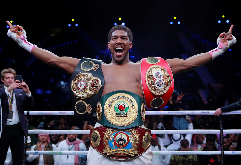 Anthony Joshua celebrates winning his match against Andy Ruiz Jr with his IBF, WBA, WBO and IBO World Heavyweight Titles in Diriyah, Saudi Arabia December 7, 2019. u00e2u20acu201d Action Images pic via Reuters