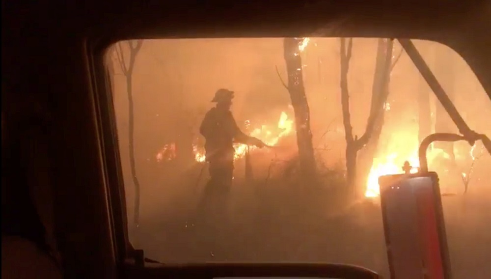 A firefighter attemps to control fire in Newnes Plateau, New South Wales December 7, 2019 in this picture grab obtained from a social media video December 8, 2019. u00e2u20acu201d Picture courtesy of Gena Dray via Reuters