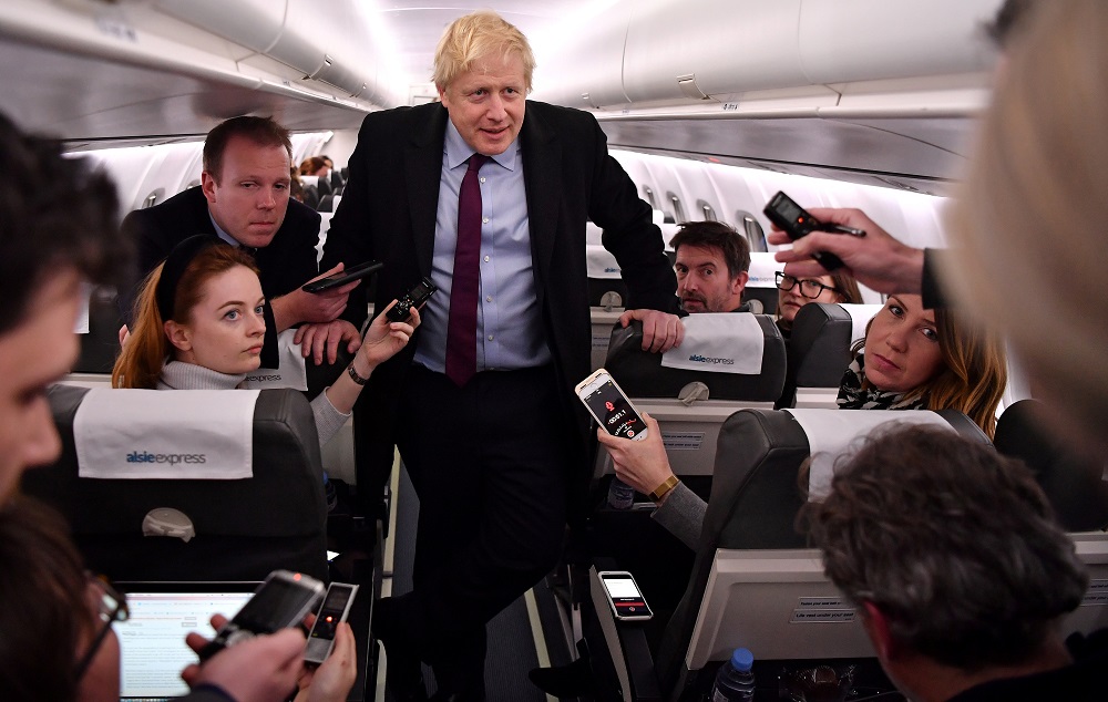 Britain's Prime Minister and Conservative leader Boris Johnson talks with journalists as he travels aboard a plane bound to Birmingham December 9, 2019. u00e2u20acu201d Reuters pic