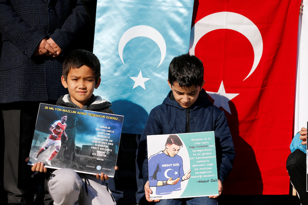 Ethnic Uighur boys hold placards with images of Arsenal midfielder Mesut Ozil during a protest against China in Istanbul December 14, 2019. The placard reads: ‘Thank you, Mesut Ozil, on behalf of 35 million oppressed’. — Reuters pic