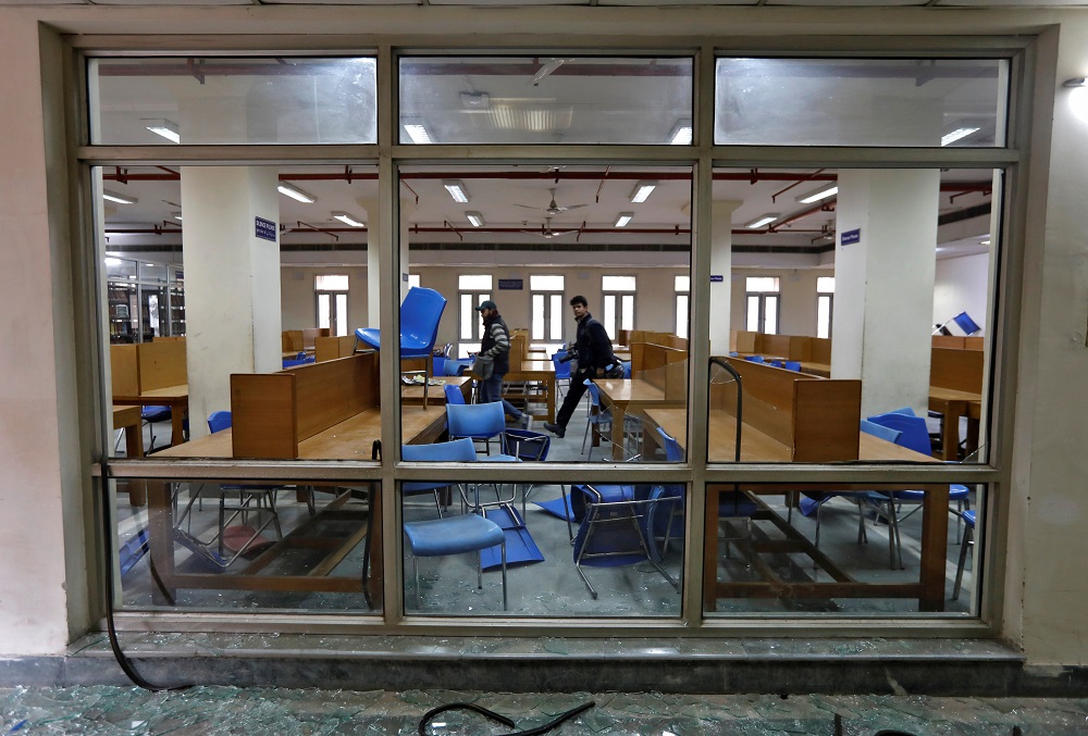 People walk inside a partially damaged library of the Jamia Millia Islamia university after police entered the university campus on the previous day, following a protest against a new citizenship law, in New Delhi December 16, 2019. — Reuters pic