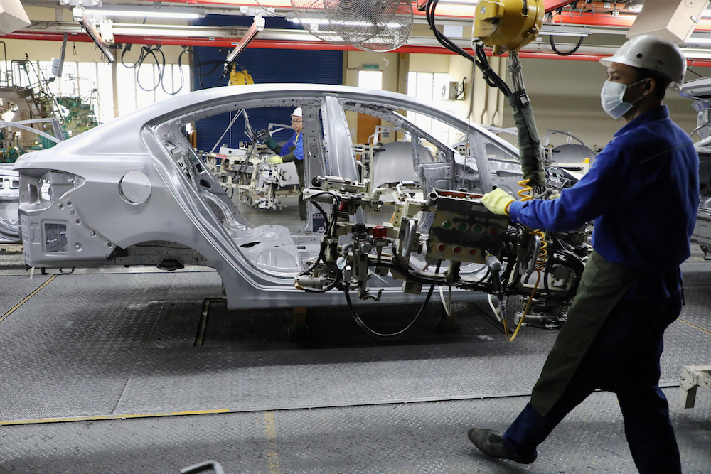 Employees work at an assembly line in the Proton manufacturing plant in Tanjung Malim December 16, 2019. u00e2u20acu201d Reuters pic