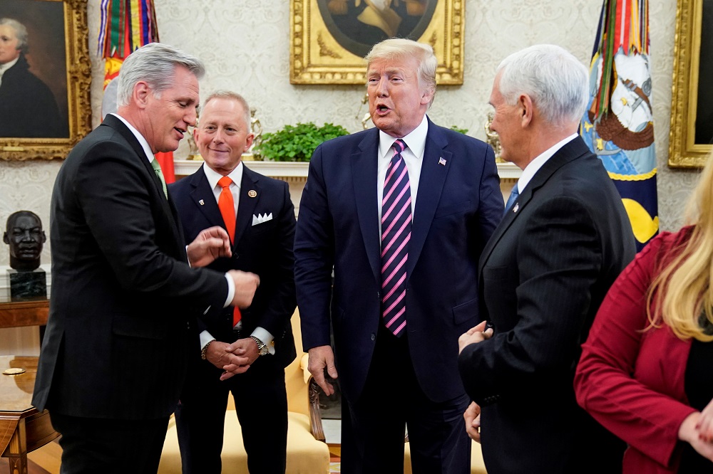 Kevin McCarthy (left) points to US President Donald Trump as he meets with US Representative Jeff Van Drew (second left) in the Oval Office of the White House in Washington December 19, 2019. u00e2u20acu201d Reuters pic