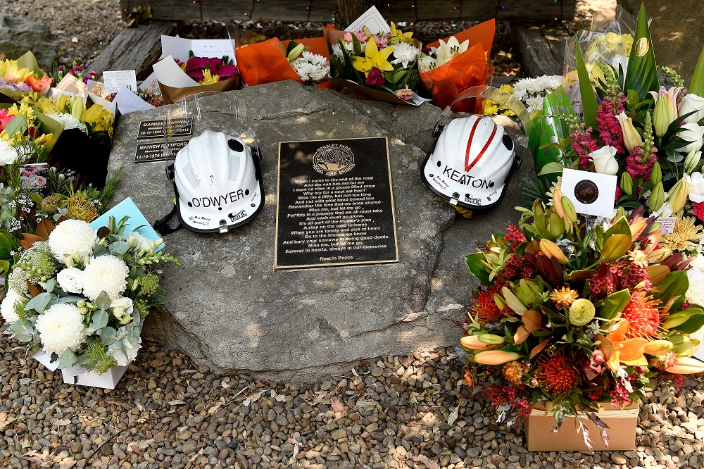 Flowers and the helmets of volunteer firefighters Andrew Ou00e2u20acu2122Dwyer and Geoffrey Keaton are seen at a memorial at the Horsley Park Rural Fire Brigade in Horsley Park, NSW December 20, 2019. u00e2u20acu201d AAP Image/Bianca De Marchi via Reuters